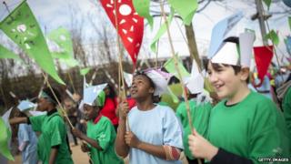 Local schoolchildren take part in an opening parade