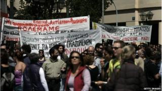 Protesters carry banners as they march towards Parliament during a labour strike on 09/04/14 in Athens, Greece.