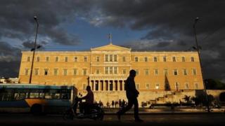 A man walks past the Greek parliament