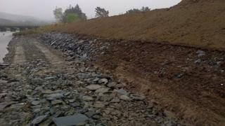 The repaired breach in the embankment
