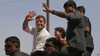 Rahul Gandhi waves to supporters, with his sister Priyanka Vadra seated by his side, in Amethi, on Saturday, April 12, 2014