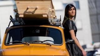 Presenter Namra Saleem with a coffin on top of her car