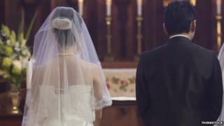 A couple getting married, seen from behind