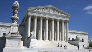People walk on the steps of the US Supreme Court in Washington on 26 April 2014