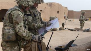 Soldiers in Afghanistan using communications equipment
