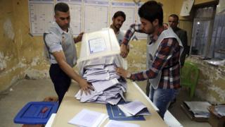 Electoral workers count ballots as polls close at a polling centre in Baghdad on 30 April 2014