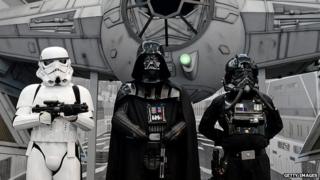 Fans dressed as Darth Vader and imperial soldiers gather at a convention in Germany on 28 July, 2013.
