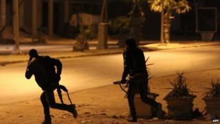 Libyan security forces are seen advancing during clashes with anti-government forces following an attack on a Benghazi police station, early on 2 May 2014