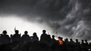 Ukrainian Army soldiers line up in front of Pro-Russia civilians who where blocking the road in the Andreevka, Ukraine, 2 May 2014
