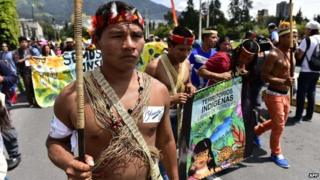 Huaorani natives and Yasunidos ecologist group activists march in Quito on April 12, 2014.