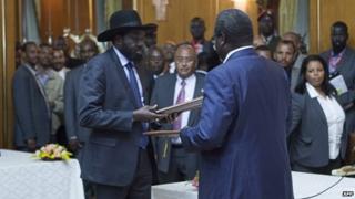 President Salva Kiir (left) and rebel leader Riek Machar after signing the deal