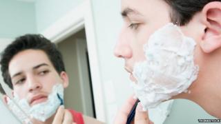 Young man shaving