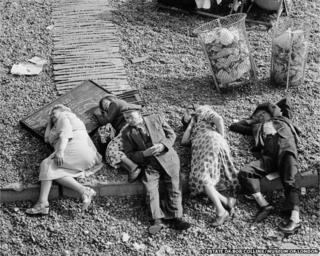 Pensioners asleep on the beach, Brighton, c.1950