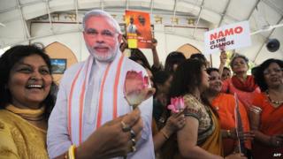An Indian woman holds a picture of opposition leader Narendra Modi