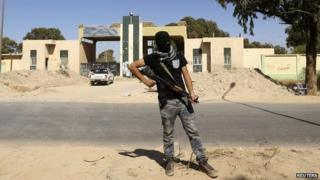 A gunman stands guard at the militia camp attacked by Khalifa Haftar's forces in Benghazi - 16 May 2014