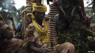 Former Seleka soldiers prepare to disembark from their vehicle in a village, where residents say was attacked and a mosque burnt the night before by anti-balaka militiamen, about 25 kilometres (16 miles) from Bambari on 10 May 2014