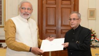 Narendra Modi (left) met President Pranab Mukherjee to claim his right to form the government