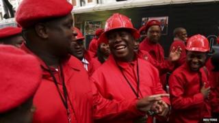 Economic Freedom Party (EFF) leader Julius Malema (C) arrives to be sworn in as a member of parliament at the South African Parliament in Cape Town on 21 May 2014