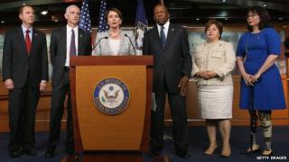 Minority Leader Nancy Pelosi (D-CA) (C) speaks while flanked by five fellow Democrats (L-R) Rep. Rep. Adam B. Schiff (D-CA), Rep. Adam Smith (D-WA), Rep. Elijah E. Cummings (D-MD), Rep. Linda Sanchez, (D-CA) and Rep. Tammy Duckworth (D-IL) during a news conference on Capitol Hill 21 May 2014