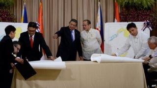Philippine President Benigno Aquino (3nd R) stands beside Indonesian President Susilo Bambang Yudhoyono (4th R) as they look at Indonesian Foreign Minister Marty Natalegawa (2nd L) and Philippine Foreign Affairs Secretary Albert del Rosario (R) signing a maritime border accord at Malacanang Palace in Manila on 23 May 2014