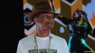Pharrell Williams smiles on stage