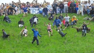 Competitors in the Cheese Rolling on Cooper's Hill race near Brockworth, Gloucestershire