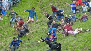 Competitors in the Cheese Rolling on Cooper's Hill race near Brockworth, Gloucestershire