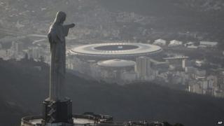 An aerial view shot of the Maracana stadium behind the Christ the Redeemer statue in Rio de Janeiro