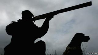 man with rifle grouse shooting