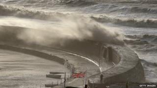 Waves breaking over the Cobb sea wall at Lyme Regis