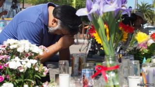 A man mourns in front of a makeshift memorial in Isla Vista, California.
