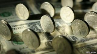 Pound coins on dollar notes