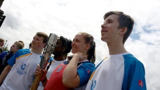 Torch bearers stand side by side in Bristol