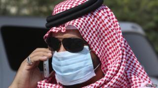 A man with mask speaks on his mobile phone in Jeddah May 29