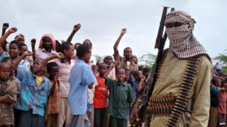 Somali boys chant as they watch hard-line Islamist fighters from al-Shabab parade during a rally in the streets of Mogadishu, Somalia - 30 October 2009
