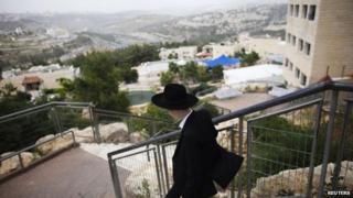An ultra-Orthodox Jewish man walks through the settlement of Ramat Shlomo (5 June 2014)
