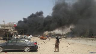 Smoke rises from the site of a car bomb attack in the town of Tuz Khurmatu, north of the capital Baghdad