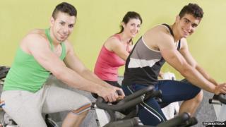 People on exercise bikes
