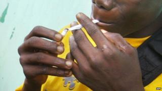 A teenager smoking marijuana in Liberia - 2003