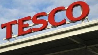 A Tesco sign on a supermarket roof