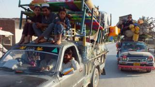 Internally displaced Pakistanis arrive in Bannu, a town on the edge of Pakistan's lawless tribal belt of Waziristan, on 11 June 2014.