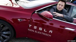Tesla head Elon Musk poses in one of his electric cars.