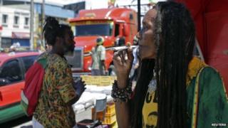 A demonstrator smokes marijuana during a march in Kingston for the legalisation of the plant. 21/04/2014