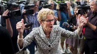 Ontario Premier Kathleen Wynne reacts as she greets supporters and staff after winning a majority government at Queen's Park in Toronto 13 June 2014