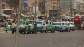 Emergency vehicles at the scene of a suicide bombing in Baghdad, 15 June 2014