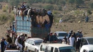 Fleeing internally displaced Pakistani, stuck in a curfew imposed due to the Afghan election, are pictured near the mountainous North Waziristan district Miranshah on June 14, 2014.