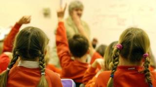 Schoolchildren in classroom with teacher