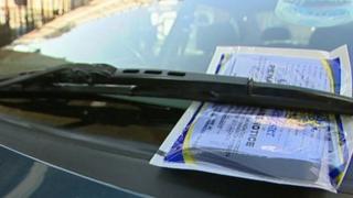 A parking ticket on a car windscreen