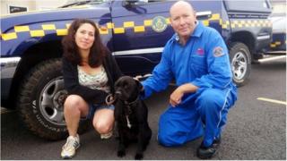 John Bunce, a member of the Torbay Coastguard rescue team, Harry, a Staffordshire bull terrier cross breed dog, and his owner Amanda Wileman