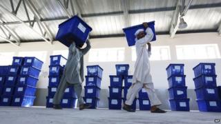 Afghan election workers carry ballot boxes at an election commission office in Jalalabad east of Kabul, Afghanistan on 12 June 2014.
